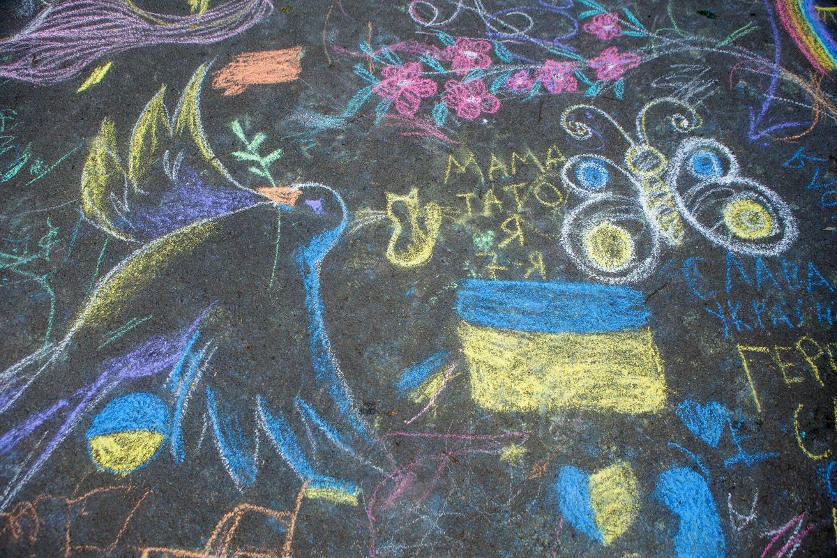 UZHHOROD, UKRAINE - MAY 14, 2022 - Children's chalk drawings are seen on the asphalt on the Uzh River embankment in Uzhhorod, Zakarpattia Region, western Ukraine. This photo cannot be distributed in the Russian Federation. (Photo credit should read Serhii Hudak/ Ukrinform/Future Publishing via Getty Images)