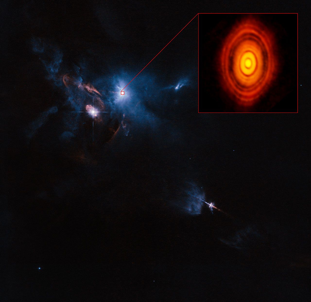 Młodziutki system HL Tauri na tle sąsiedztwa sfotografowanego przez teleskop Hubble'a