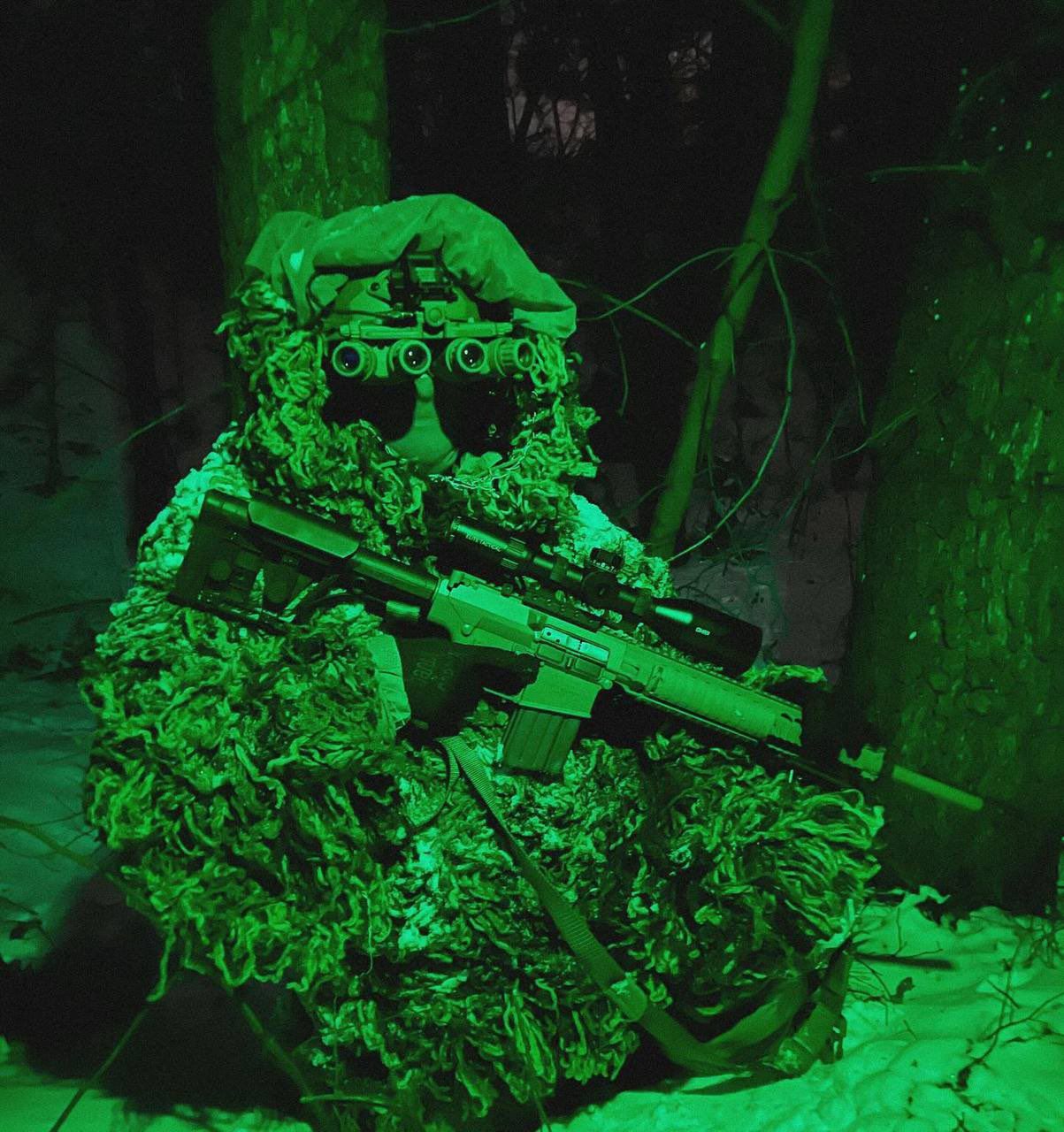 A Ukrainian sniper from special units equipped with an M110 SASS rifle and panoramic night vision goggles GPNVG.