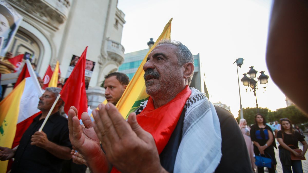 Tunisians holding banners and flags, gather at Habib Bourguiba Avenue to stage a demonstration against Israeli attacks in Lebanon and to commemorate the victims of the attacks, including Hezbollah Secretary General Hassan Nasrallah in Tunis, Tunisia on October 02, 2024. (Photo by: Hasan Mrad/UCG/Universal Images Group via Getty Images)