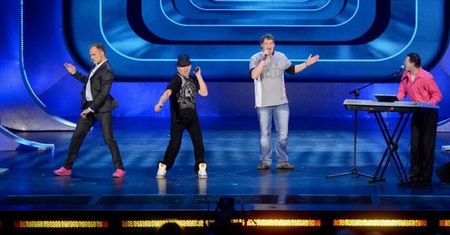 Piotr Rogucki tańczy na scenie z twórcami "Różowej taczki"