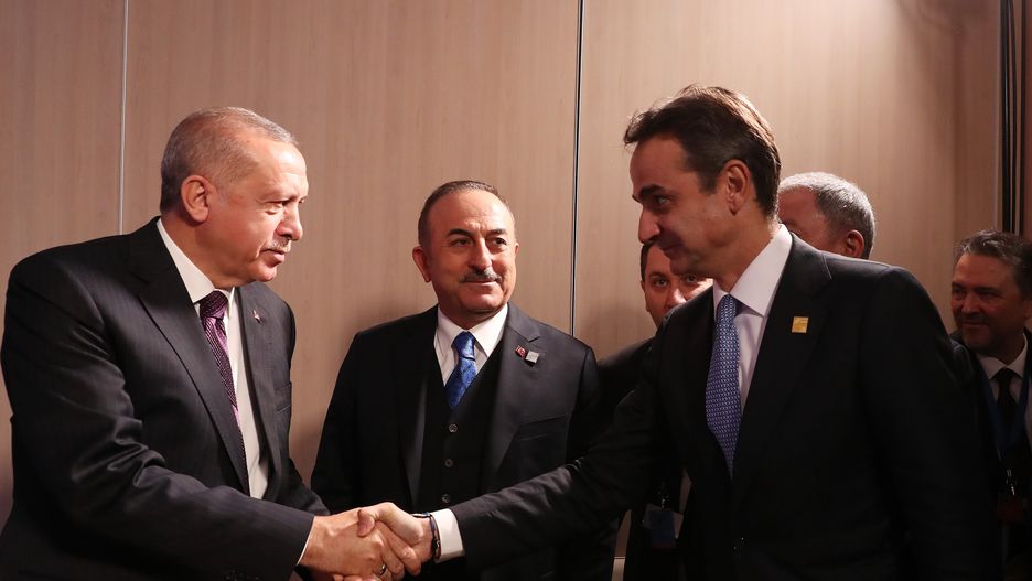 LONDON, UNITED KINGDOM - DECEMBER 04: (----EDITORIAL USE ONLY  MANDATORY CREDIT - "TURKISH PRESIDENCY / MURAT CETINMUHURDAR / HANDOUT" - NO MARKETING NO ADVERTISING CAMPAIGNS - DISTRIBUTED AS A SERVICE TO CLIENTS----) Turkish President Recep Tayyip Erdogan (L) shakes hands with Greek Prime Minister Kyriakos Mitsotakis (R) prior to their meeting within the NATO Leaders' Summit at the Grove Hotel in London on December 04, 2019. Turkish Foreign Minister Mevlut Cavusoglu (C) also attended the meeting. (Photo by Turkish Presidency / Murat Cetinmuhurdar / Handout/Anadolu Agency via Getty Images)