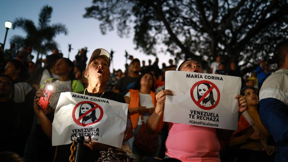 CARACAS, VENEZUELA - JULY 30: Pro-government supporters display signs against opposition leader Maria Corina Machado during a speech by President Nicolas Maduro on July 30, 2024 in Caracas, Venezuela. President of Venezuela Nicolas Maduro was declared the winner of the 2024 presidential election over his rival, Edmundo Gonzalez. The result has been questioned by the opposition and internationally. According to the opposition leader Maria Corina Machado, the result announced by the 'Consejo Nacional Electoral' (CNE) does not reflect the decision made by the Venezuelans during the election.  (Photo by Jesus Vargas/Getty Images)