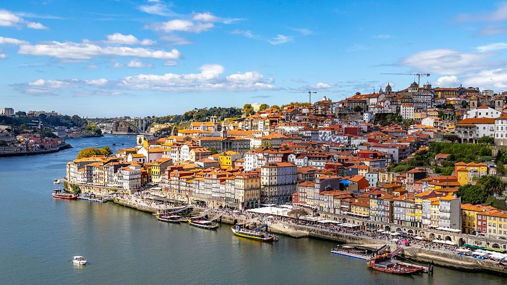 Aerial view of Porto city center and waterfront along the Douro river
Porto historic city center viewed from the Dom Luis bridge, the historic center of the city includes the Ribeira district and waterfront cafes and bars. (Photo by: Martin Berry/UCG/Universal Images Group via Getty Images)
UCG
vacation, getaway, old city, travel destination, rabelo boats, european