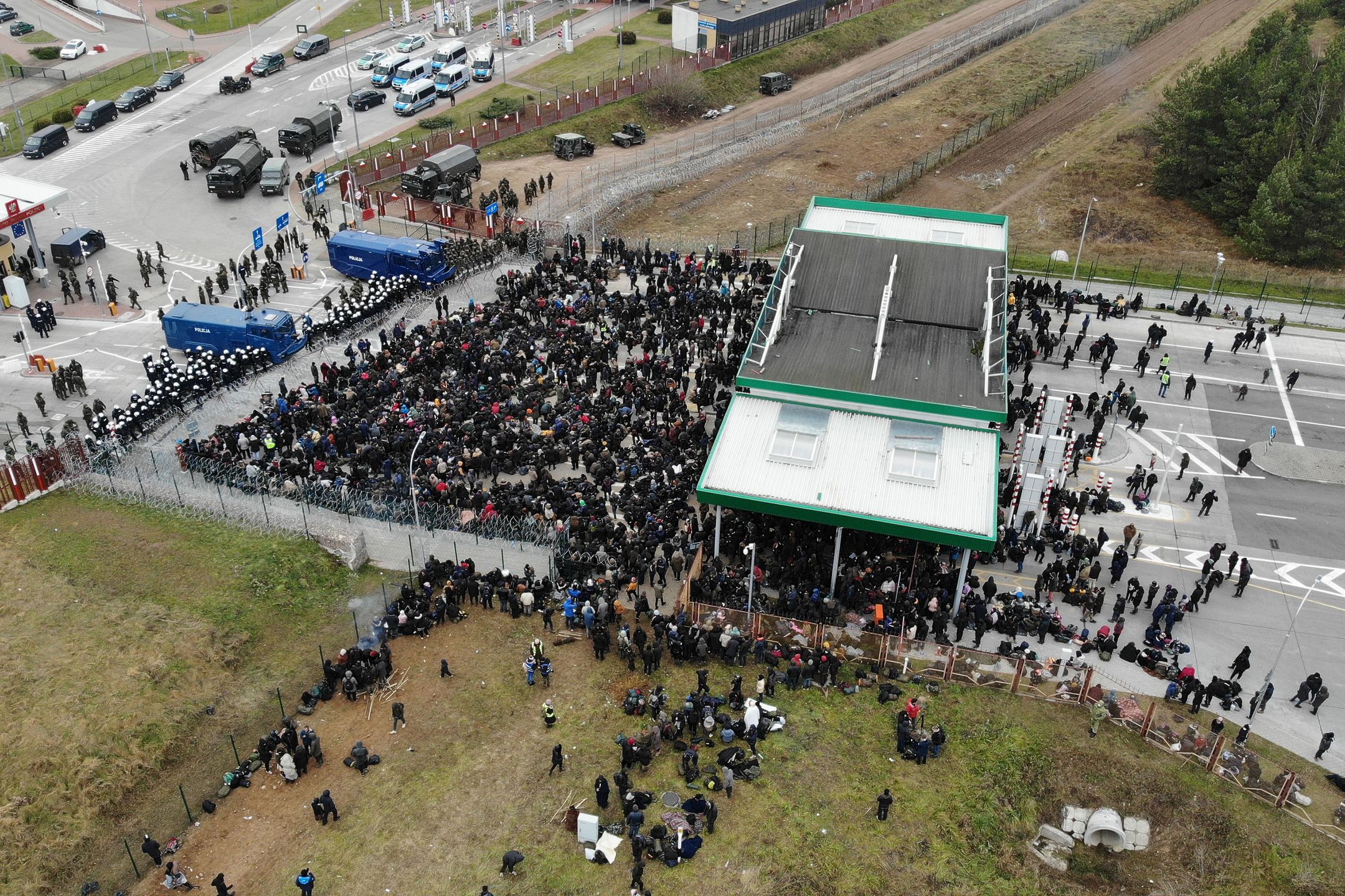 GRODNO REGION, BELARUS - NOVEMBER 15, 2021: Migrants at the Bruzgi - Kuznica checkpoint on the Belarusian-Polish border. The migrant crisis on the border of Belarus with Poland, Lithuania, and Latvia escalated on November 8. Several thousand migrants approached the Belarusian-Polish border and set up a tent camp there; some of them tried to cross the border by breaking a barbed wire fence. Leonid Shcheglov/BelTA/TASS (Photo by Leonid Shcheglov\TASS via Getty Images)