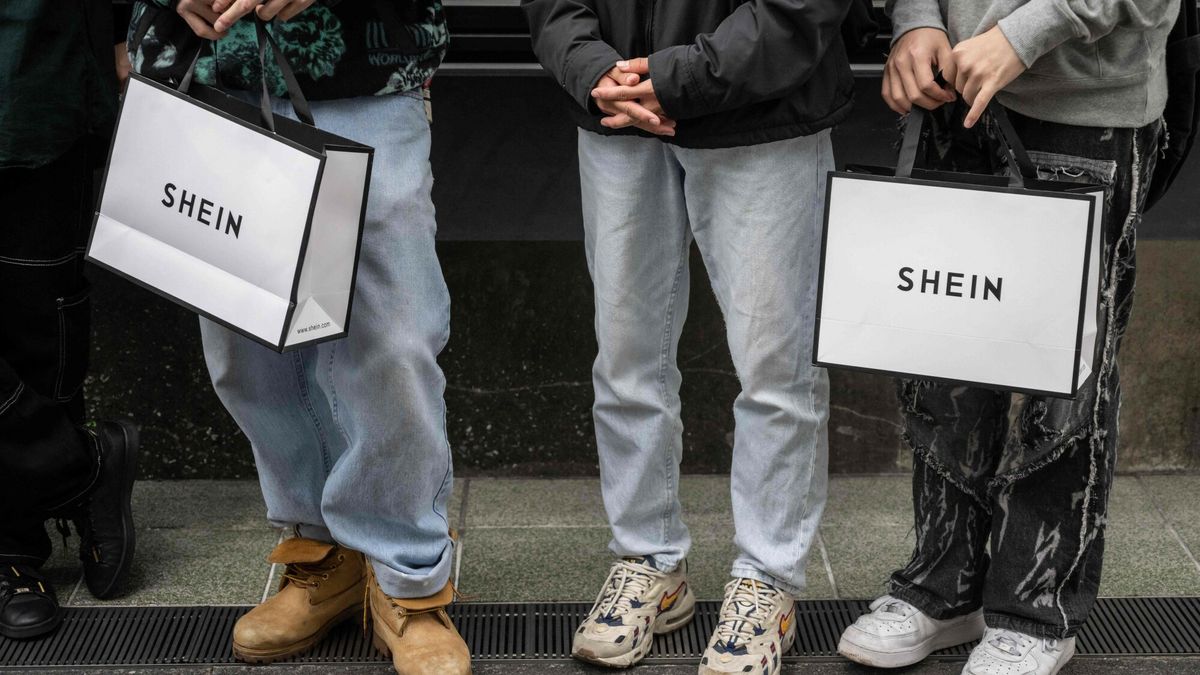Temporary
People holding Shein shopping bags stand outside the first permanent showroom of Chinese online fast fashion giant Shein on the opening day of the shop in Tokyo on November 13, 2022. (Photo by Yuichi YAMAZAKI / AFP)
YUICHI YAMAZAKI
