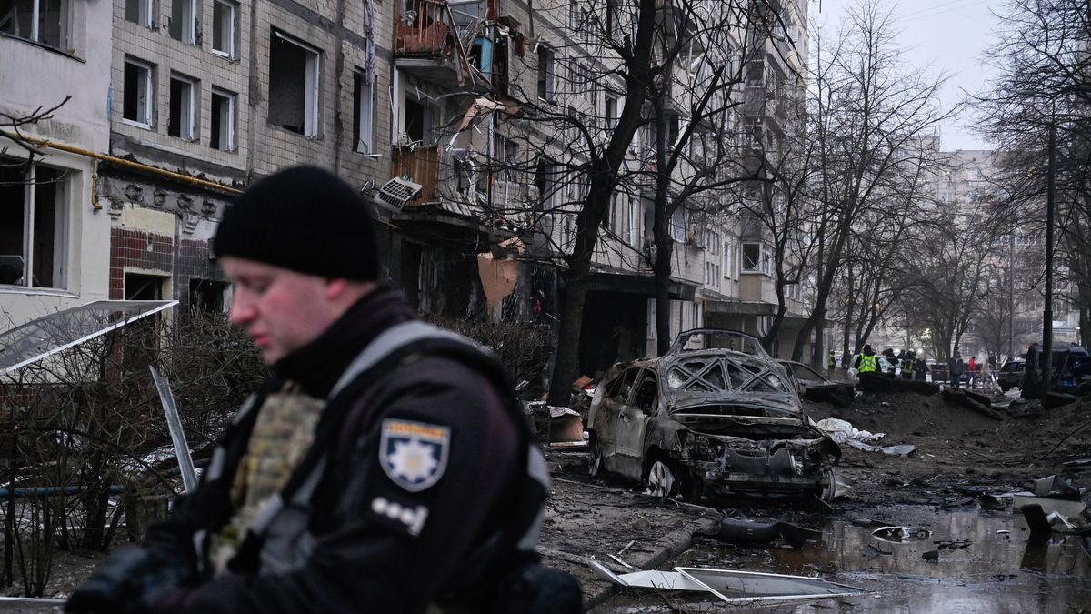 KYIV, UKRAINE - 2023/12/13: The police stand close to a residential building damaged by debris from a missile attack by the Russian army. On December 13, the Russian army attacked the capital of Ukraine with ballistic missiles. All ten missiles were shot down by air defense forces. Fifty-three people were injured as a result of the rocket attack. (Photo by Sergei Chuzavkov/SOPA Images/LightRocket via Getty Images)