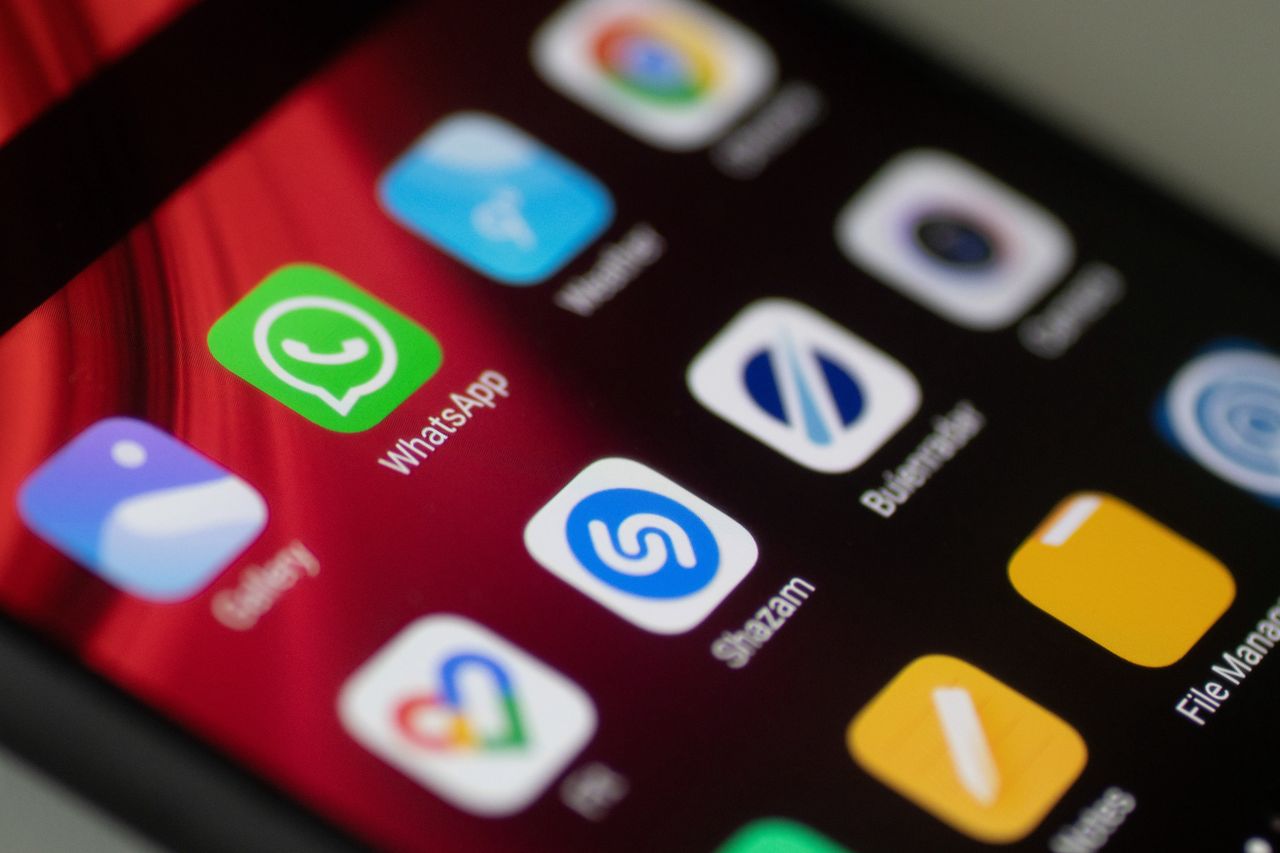 WhatsApp logo displayed on a phone screen, smartphone and keyboard are seen in this multiple exposure illustration. WhatsApp Messenger is a multiplatform mobile application that provides an encrypted instant messaging system belonging to Facebook, photo taken in Amsterdam, Netherlands on January 28, 2020 (Photo illustration by Nicolas Economou/NurPhoto via Getty Images)