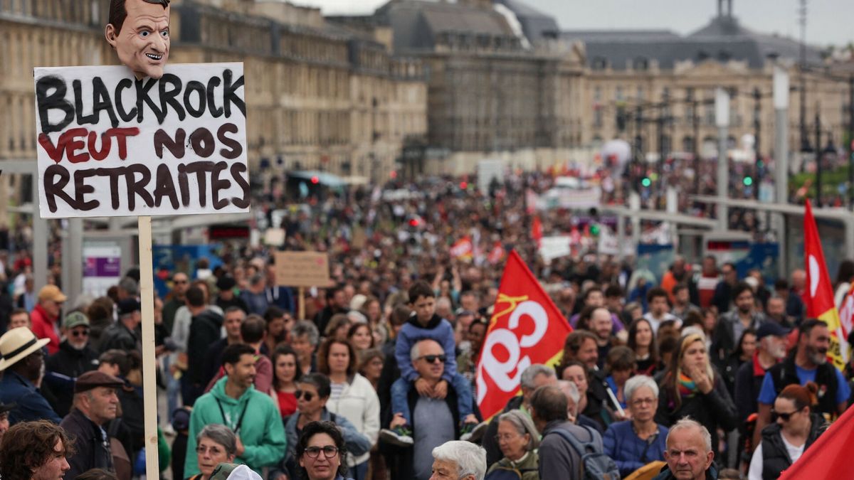 TemporaryA placard which reads "Backrock wants our pensions" is pictured as rotesters march along Quai de Richelieu along the Garonne river during a demonstration on May Day (Labour Day), to mark the international day of the workers, more than a month after the government pushed an unpopular pensions reform act through parliament, in Bordeaux, southwestern France, on May 1, 2023. - Opposition parties and trade unions have urged protesters to maintain their three-month campaign against the law that will hike the retirement age to 64 from 62. (Photo by Thibaud MORITZ / AFP)THIBAUD MORITZ
