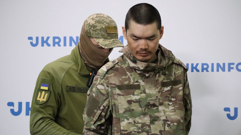 KYIV, UKRAINE - APRIL 14: A Security Service of Ukraine officer escorts Chinese national Wang Guangjun to the press conference on April 14, 2025 in Kyiv, Kyiv Oblast, Ukraine. Chinese nationals Zhang Renbo and Wang Guangjun were fighting in the ranks of the Russian army and were captured by Ukrainian Defense Forces in Donetsk Oblast in early April. (Photo by Andriy Zhygailo/Oboz.ua/Global Images Ukraine via Getty Images)