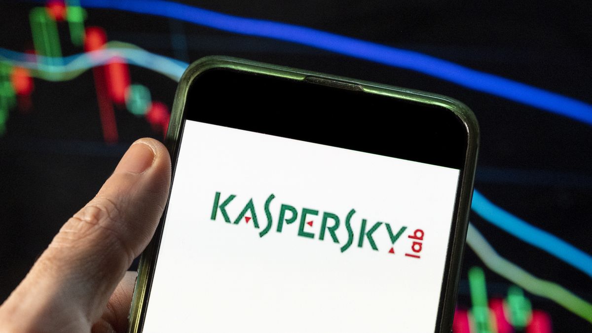 CHINA - 2021/12/09: In this photo illustration the multinational cybersecurity and anti-virus software provider Kaspersky Lab logo seen displayed on a smartphone with an economic stock exchange index graph in the background. (Photo Illustration by Budrul Chukrut/SOPA Images/LightRocket via Getty Images)