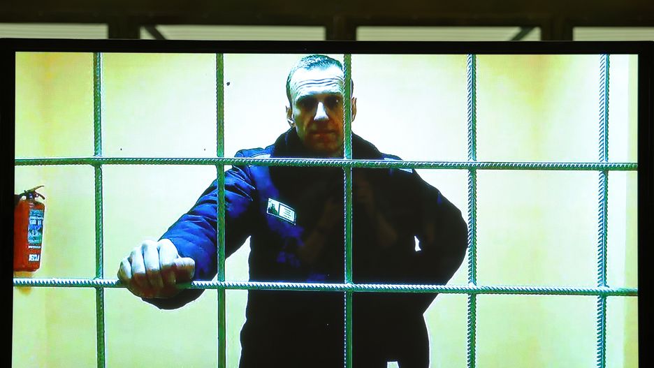 Russian opposition leader Alexei Navalny is seen on a screen via video link from the IK-2 corrective penal colony in Pokrov before a court hearing to consider an appeal against his prison sentence, in Moscow, Russia May 17, 2022.