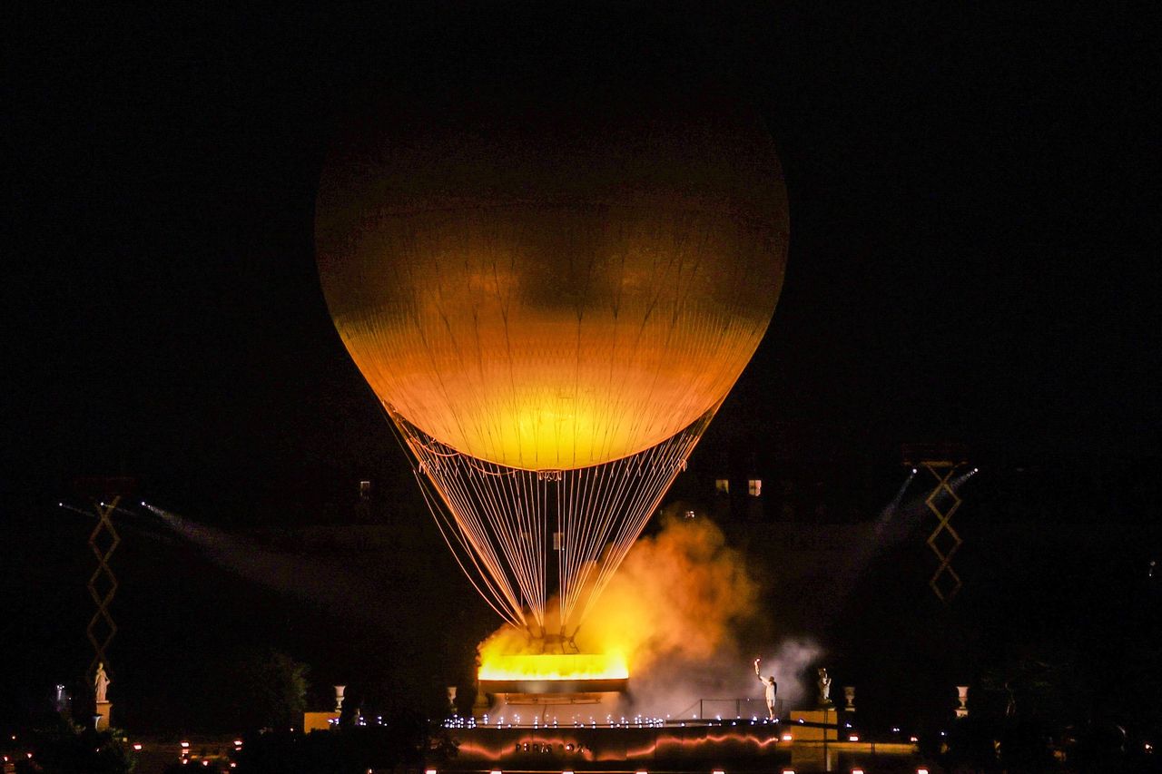 The Olympic torch in Paris takes the form of a balloon with a burning cauldron, floating above the city.