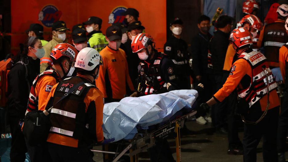 SEOUL, SOUTH KOREA - OCTOBER 30: Emergency services transport a person after a stampede during a Halloween celebration October 30, 2022 in Seoul, South Korea. Fifty-nine people have been reported killed and at least 150 others were injured in a deadly stampede in Seoul's Itaewon district, after huge crowds of people gathered at Halloween parties, according to fire authorities. (Photo by Chung Sung-Jun/Getty Images)