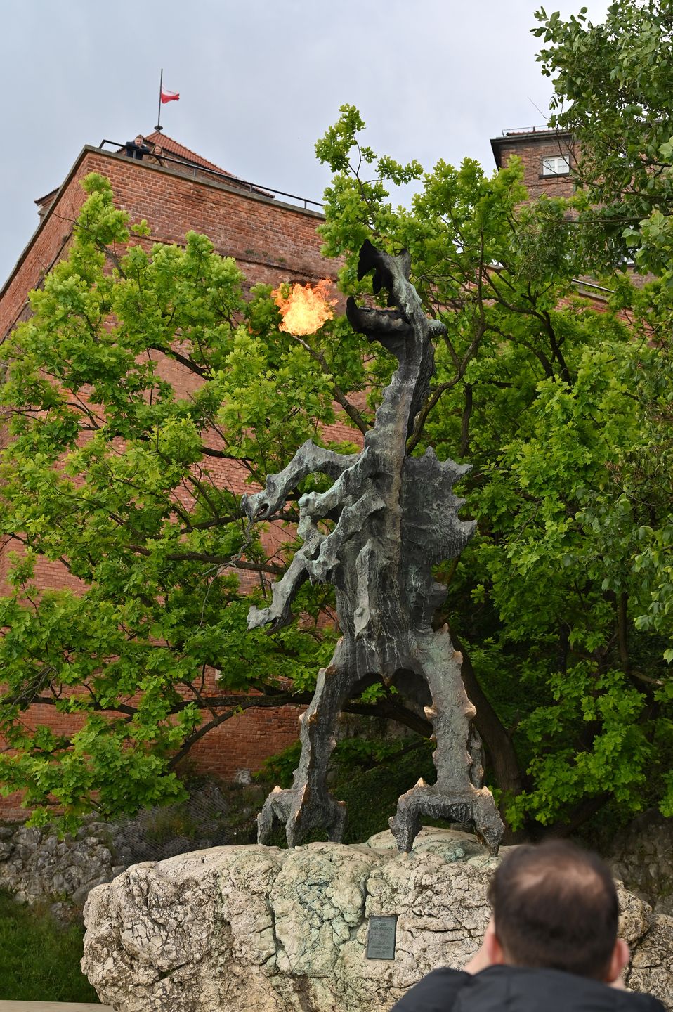 KRAKOW, POLAND - MAY 19: People take photographs of the fire breathing dragon statue monument also known as the Smok Wawelski outside the Wawel Royal Castle (Zamek Królewski na Wawelu) on May 19, 2025 in Krakow, Poland. (Photo by John Keeble/Getty Images)