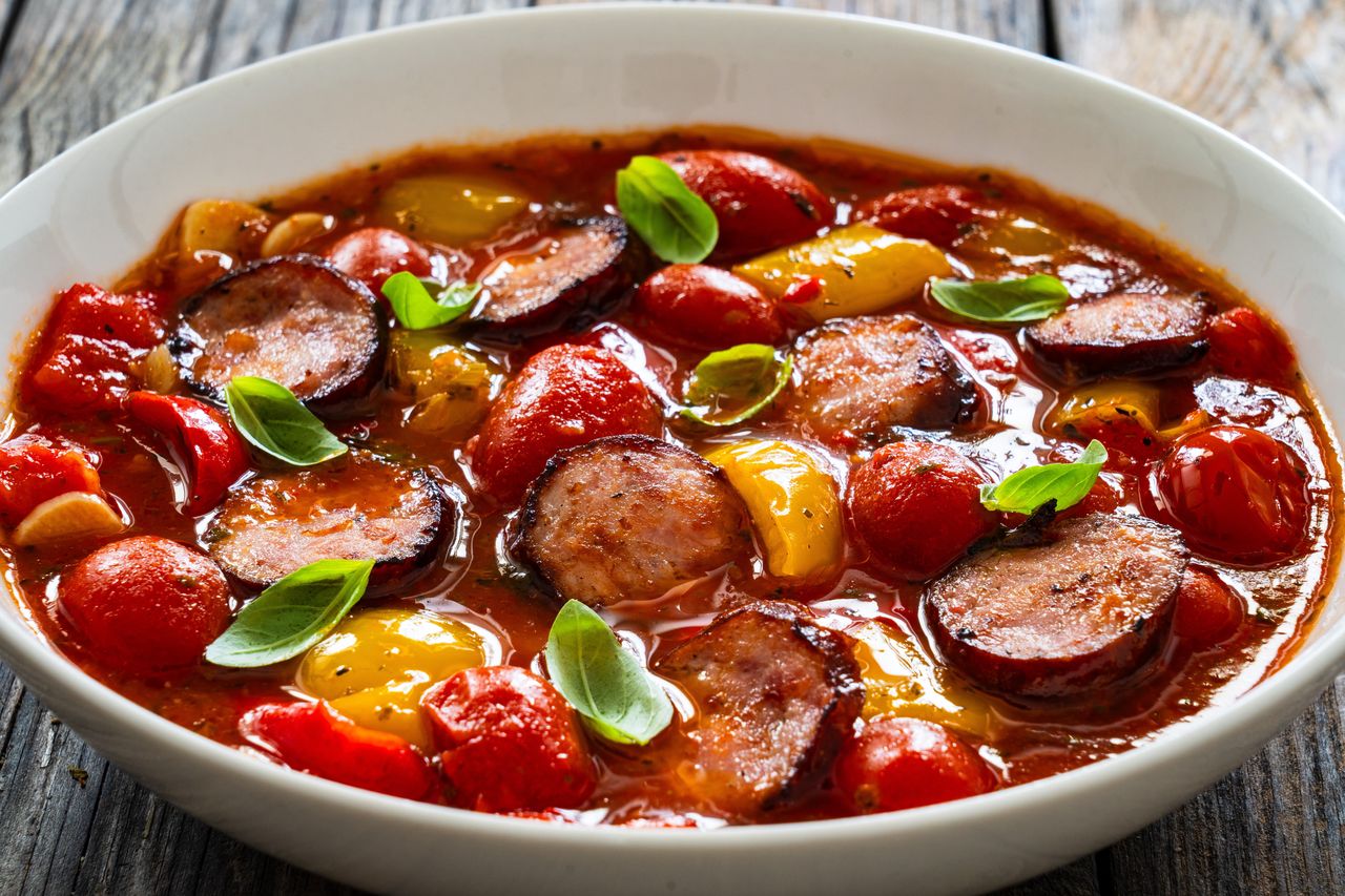 I enhance sausage, tomato, and pepper stew with 1 sweet ingredient.