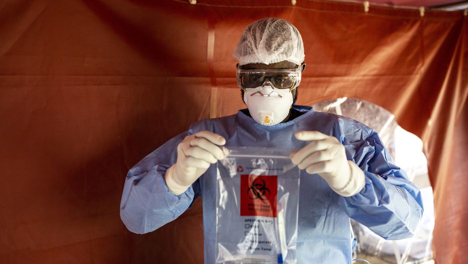 A doctor dressed in personal protective equipment (PPE) sealed a bag containing an oropharyngeal swab samples for Covid-19 testing at the Aga Khan University Hospital in Nairobi, Kenya, on Friday, April 24, 2020. The East African country enforced a curfew as part of measures to reduce the risk of contagion amid fears that Covid-19 patients will overrun its health system. Photographer: Patrick Meinhardt/Bloomberg via Getty Images