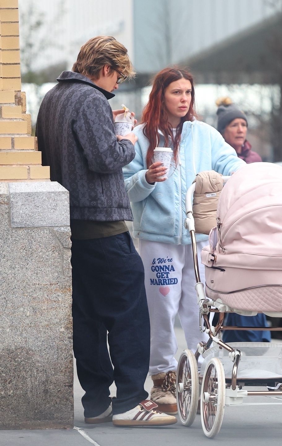 *EXCLUSIVE* Cozied Up Family! Millie Bobby Brown and Jake Bongiovi pushing a stroller with their adopted baby daughter in New York City **WEB MUST CALL FOR PRICING**BlayzenPhotos / BACKGRID / Backgrid USA / ForumMillie Bobby Brown, Jake Bonjovi, West Village, shopping, Golden Goose, daughter, pink stroller