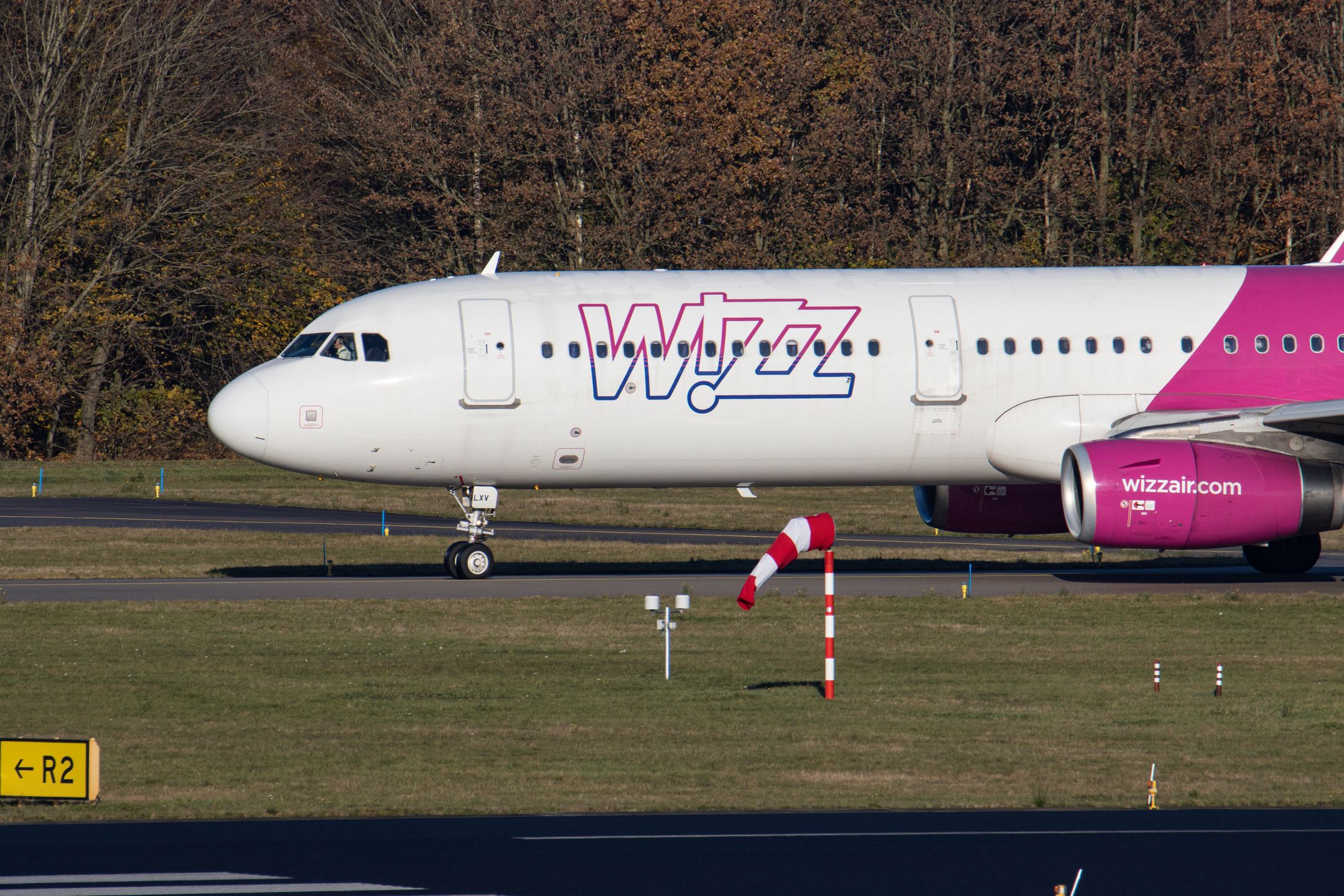 Wizz Air Airbus A321 aircraft as seen during taxiing, take off and flying phase departing from Eindhoven airport EIN during a blue sky sunny winter day.  W!ZZ Air is a Hungarian Ultra Low Cost Airline Carrier with the largest bases at Budapest Airport and Luton Airport flying to 164 airports. The A321-200 plane with the logo inscription on the side has the registration HA-LXV. The world aviation industry is trying to recover from the negative impact of the Covid-19 Coronavirus pandemic. Eindhoven, The Netherlands on November 22, 2021 (Photo by Nicolas Economou/NurPhoto via Getty Images)