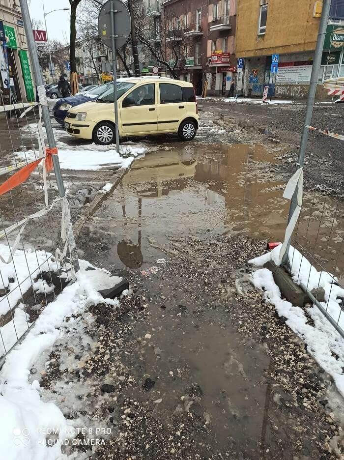 Błoto i kałuże na tymczasowym przejściu w rejonie budowy dworca metropolitalnego