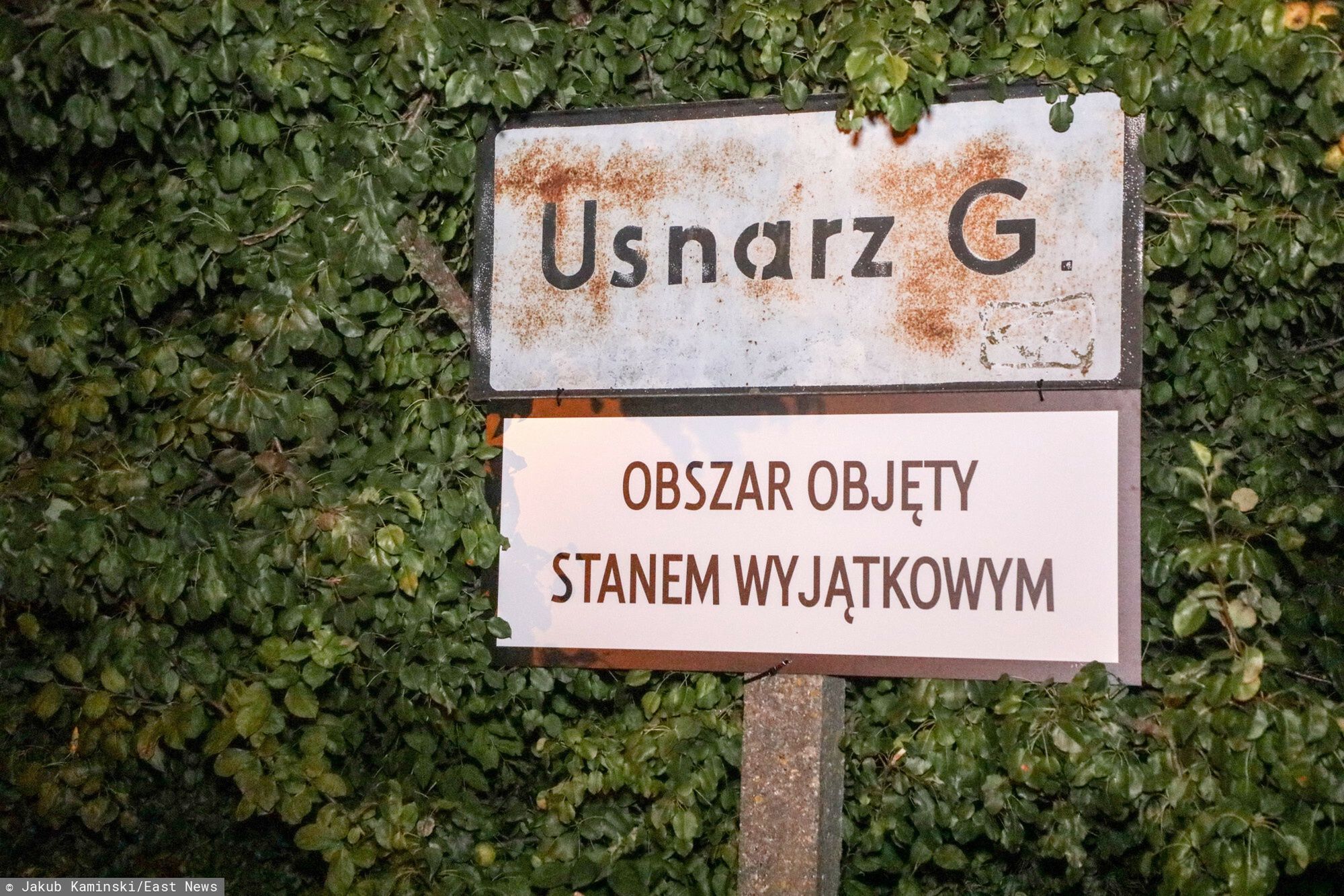 Stan wyj?tkowy na granicy z Bia?orusi?Fot. Jakub Kaminski/East News, Usnarz Gorny (woj. podlaskie), 02.09.2021. Granica polsko-bialoruska. Prezydent wydal 2 bm. rozporzadzenie o wprowadzeniu 30-dniowego stanu wyjatkowego na obszarze czesci wojewodztwa podlaskiego i lubelskiego. N/z noc przy obozowisku w Usnarzu Gornym - tabliczka z napisem "Obszar objety stanem wyjatkowym".Jakub Kaminski