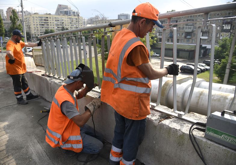 KYIV, UKRAINE - JUNE 20, 2024 - Workers repair part of the pedestrian section of the Povitroflotskyi Overpass which collapsed onto tram tracks on Wednesday, June 19, in Kyiv.  (Photo credit should read Kaniuka Ruslan / Ukrinform/Future Publishing via Getty Images)