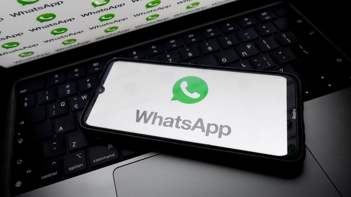 The WhatsApp logo appears on a smartphone screen and as a background on a computer screen in this photo illustration in Athens, Greece, on August 6, 2025. WhatsApp takes down 6.8 million accounts linked to scammers targeting people around the world in the first half of this year, its parent company Meta says. (Photo by Nikolas Kokovlis/NurPhoto via Getty Images)