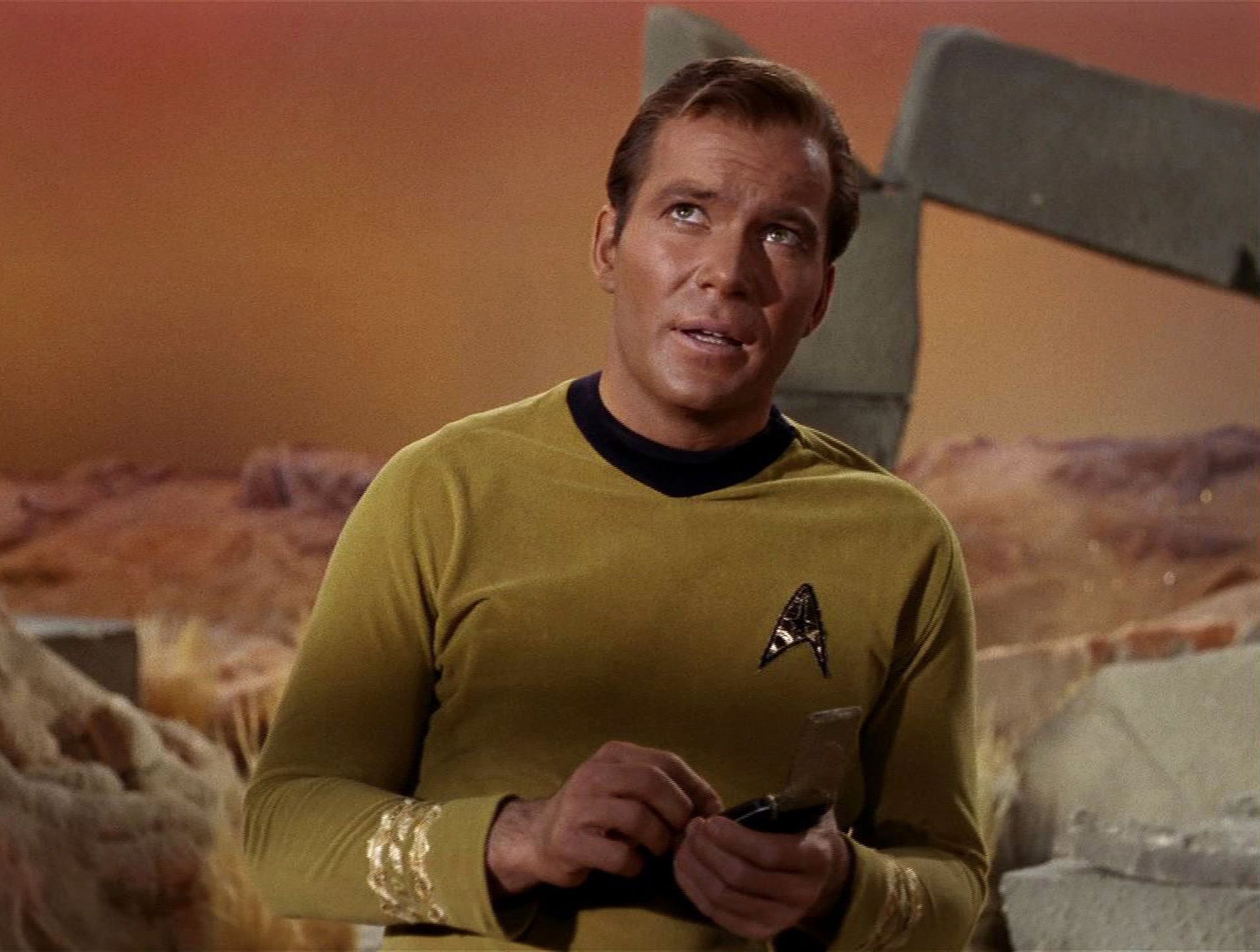 Shatner As Kirk In 'Star Trek'Canadian actor William Shatner glances upwards in a scene from an episode of the television series 'Star Trek' entitled 'The Man Trap,' 1966. The episode was the first broadcast episode of the influential series--it originally aired on September 8, 1966. (Photo by CBS Photo Archive/Getty Images)CBS Photo ArchiveT1505417, actor, television still, screen capture, Canadian, male, science fiction, badge, E_01_The_Man_Trap_162.jpg, Television & Radio, photograph