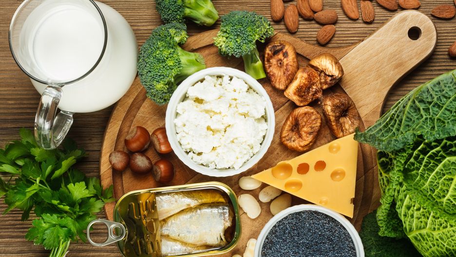 Foods rich in calcium such as sardines, bean, dried figs, almonds, cottage cheese, hazelnuts, parsley leaves, blue poppy seed, broccoli, italian cabbage, cheese, milksardines, bean, dried figs, almonds, cottage cheese, hazelnuts, parsley leaves, blue poppy seed, broccoli, italian cabbage, calcium, rich, food, wooden, background, dairy, cheese, yellow, cutting, board, nobody, top, view, vitamin, fish, D, fruit, vegetable, natural, health, healthy, source, collection, milk