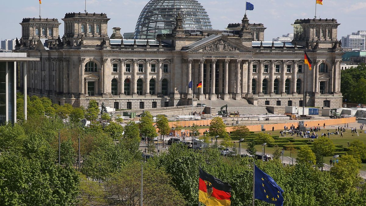 BERLIN, GERMANY - MAY 12: The Reichstag, the seat of the German federal parliament, or Bundestag, is seen as German and European Union (EU) flags fly, on May 12, 2023 in Berlin, Germany. The building opened in 1894, was damaged by fire in 1933, left abandoned and then was put back into use after renovations by Sir Norman Foster following German reunification in 1990, when government institutions began moving from the West German capital of Bonn back to the former capital of Berlin in a united Germany.  (Photo by Adam Berry/Getty Images)