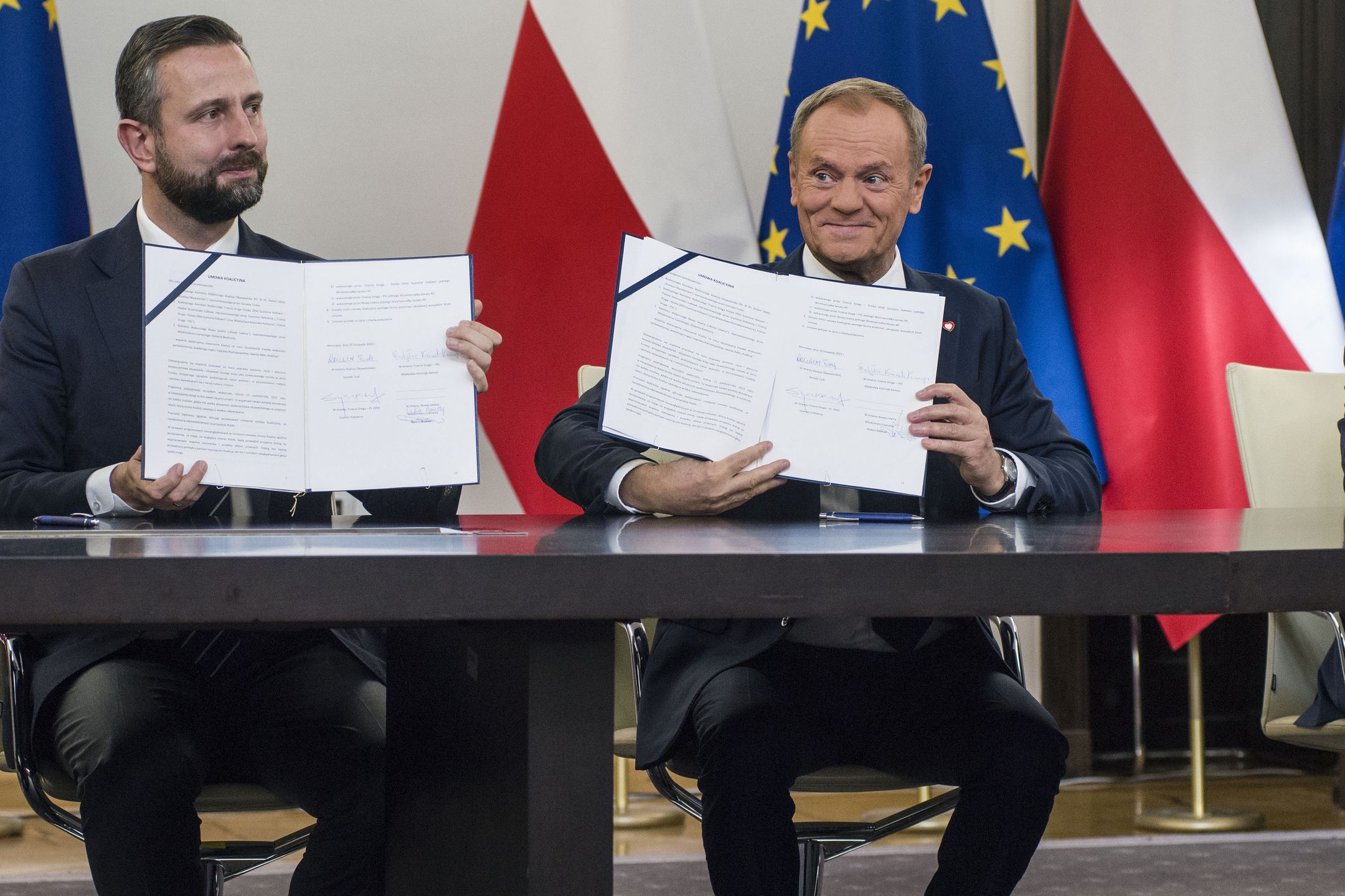 WARSAW, POLAND - 2023/11/10: Wladyslaw Kosiniak-Kamysz (L), head of the Polish People's Party, Donald Tusk (C), head of the Civic Coalition, Wlodzimierz Czarzasty (R), the co-chairman of the New Left party, show the signed coalition agreement in the Parliament. The leaders of Polish opposition parties have signed a coalition agreement that lays out a road map for governing the nation over the next four years. The parties collectively won a majority of votes in last month's parliamentary election. Their candidate to be the next prime minister is Donald Tusk, a former prime minister who leads the largest of the opposition parties, the centrist Civic Platform. Tusk said the parties worked to seal their agreement a day before the Independence Day holiday, adding that, "We wanted to show that we are ready to take responsibility for our homeland." He said the agreement would offer a set of "signposts and recommendations" for the government he plans to lead. (Photo by Attila Husejnow/SOPA Images/LightRocket via Getty Images)
