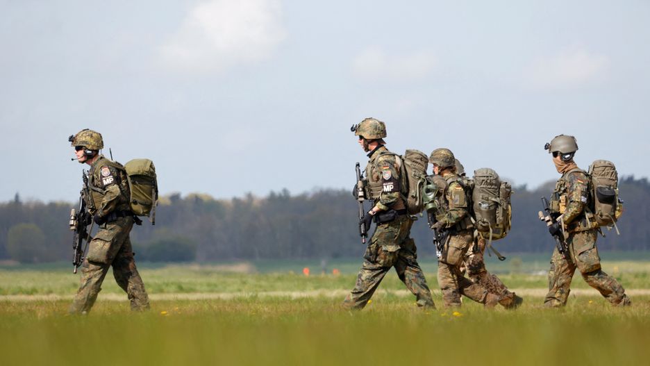 Memebers of "Feldjaeger" military police of the German army Bundeswehr arrive during the "Schnelles Adler" or "Fast Eagle" exercise of evacuation of refugees at an airport in Barth, North Germany May 5, 2022.