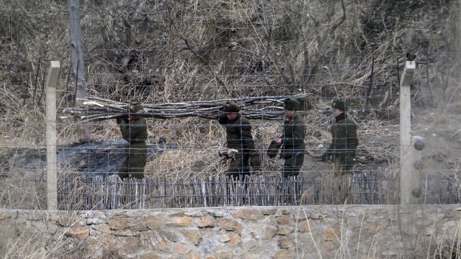 Korea P�?nocna widziana z chi?skiej granicy
This picture taken on February 27, 2024 shows North Korean soldiers working on the border as seen from Tumen in China's northeast Jilin province. North Korean soldiers gaze across an icy river towards China, occasionally descending from looming watchtowers to prowl border paths behind barbed wire and sharpened sticks.
This remote stretch of frontier was virtually inaccessible to reporters while Beijing and Pyongyang upheld some of the world's strictest pandemic-era travel curbs.
After the restrictions were unwound, an AFP team travelled to the region in late February -- peering back at the guards standing sentry at the entrance to the secretive nuclear nation.
Between rusting factories and peeling housing blocks were glimpses of everyday life, as North Koreans eked out their living by hauling timber and burning crop fields.
In one town, two goods trucks waited patiently on a bridge into China -- a sign of resumption in the cross-border trade crucial to Pyongyang's moribund economy.
North Korea's chronic food shortages are believed to have grown more acute during the pandemic, and campaigners say authorities have strengthened border defences to prevent escapes to its vast, wealthy neighbour.
Beyond the eagle-eyed guards, portraits of the ruling Kim dynasty watched over the populace, while monumental propaganda banners lauded their socialist ideology.
One slogan, written in huge red and white letters on a hillside, simply blared: "Our country is the best!" (Photo by Pedro PARDO / AFP) / To go with China-NKorea-politics, REPORTAGE
PEDRO PARDO