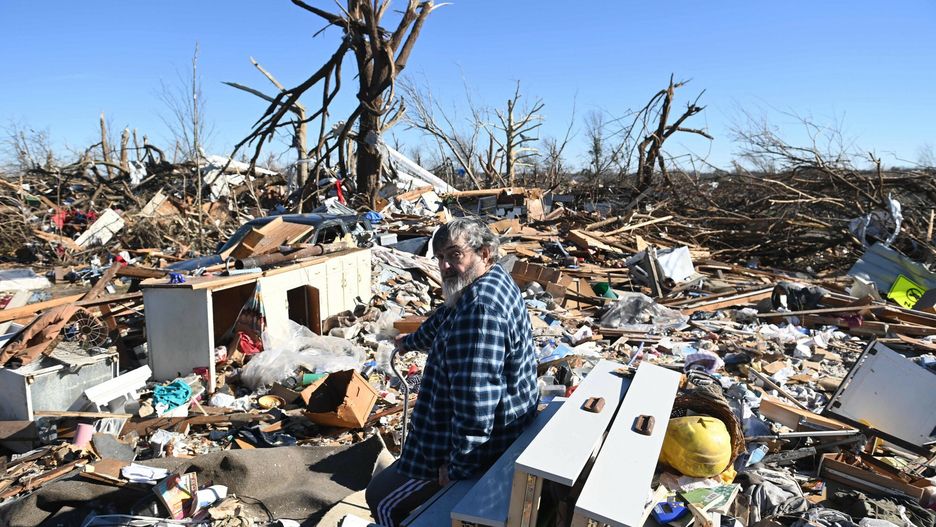 TemporaryBogdan Gaicki surveys tornado damage after extreme weather hit the region December 12, 2021, in Mayfield, Kentucky. - Dozens of devastating tornadoes roared through five US states overnight, leaving more than 80 people dead Saturday in what President Joe Biden said was "one of the largest" storm outbreaks in history. (Photo by Brendan SMIALOWSKI / AFP)BRENDAN SMIALOWSKI