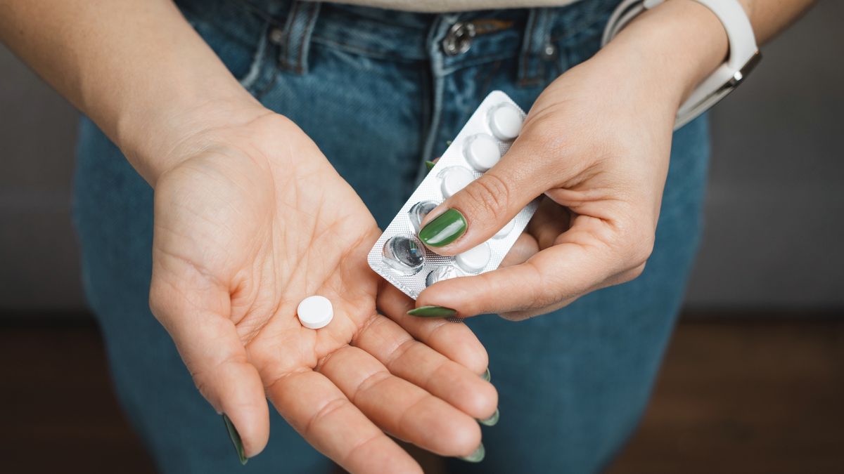 Young woman holds white pill in a hand, take medicine from blister pack, close-up view
Young woman holds white pill in a hand, take medicine from blister pack, close-up view.
Farion_O