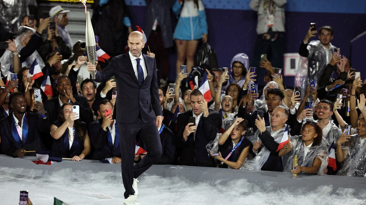 Zinedine Zidane with the Olympic Flame during the opening ceremony of the Paris 2024 Olympic Games. Picture date: Friday July 26, 2024. (Photo by Christophe Petit Tesson/PA Images via Getty Images)