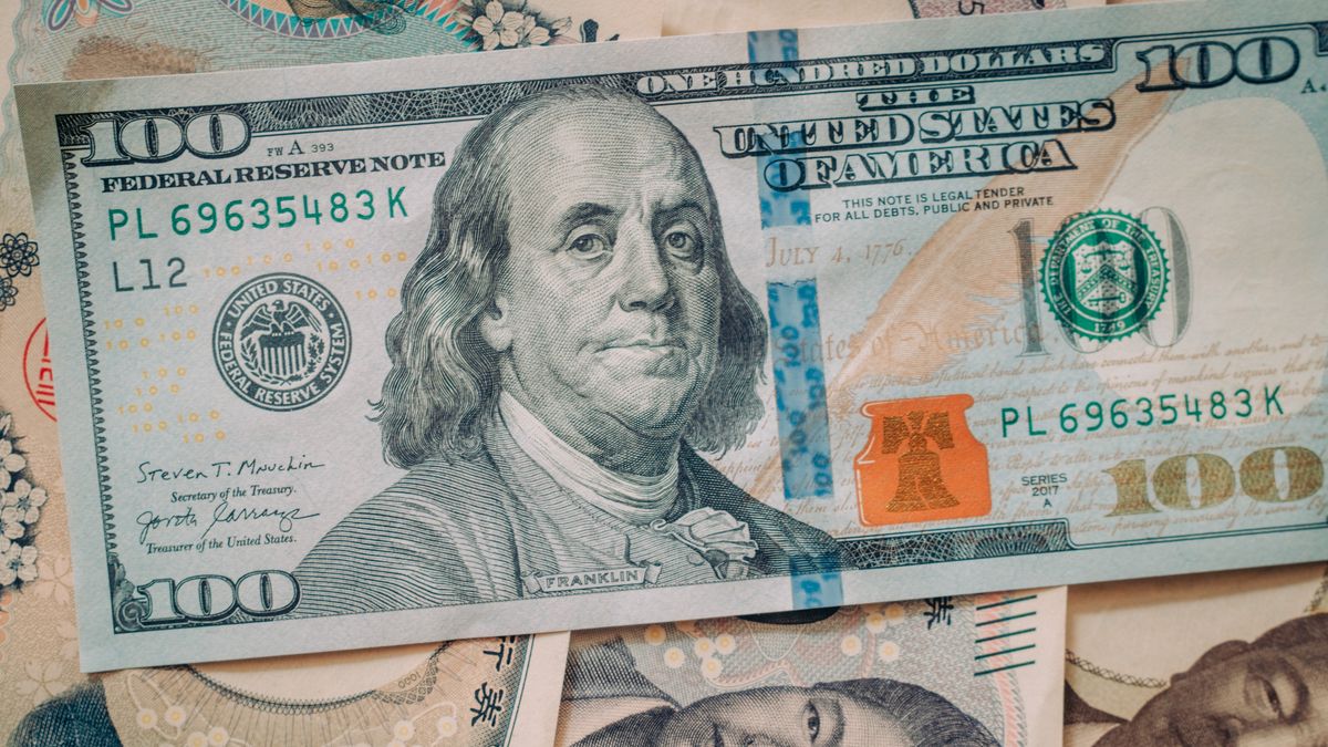 A US 100 dollar banknote and Japanese yen banknotes arranged in Kyoto, Japan, on Tuesday, July 14, 2026. The Japanese government's push for pension funds and individuals to invest more in domestic markets is seen as a potential boost for the nation's bonds and currency in the long term. Photographer: Kentaro Takahashi/Bloomberg via Getty Images