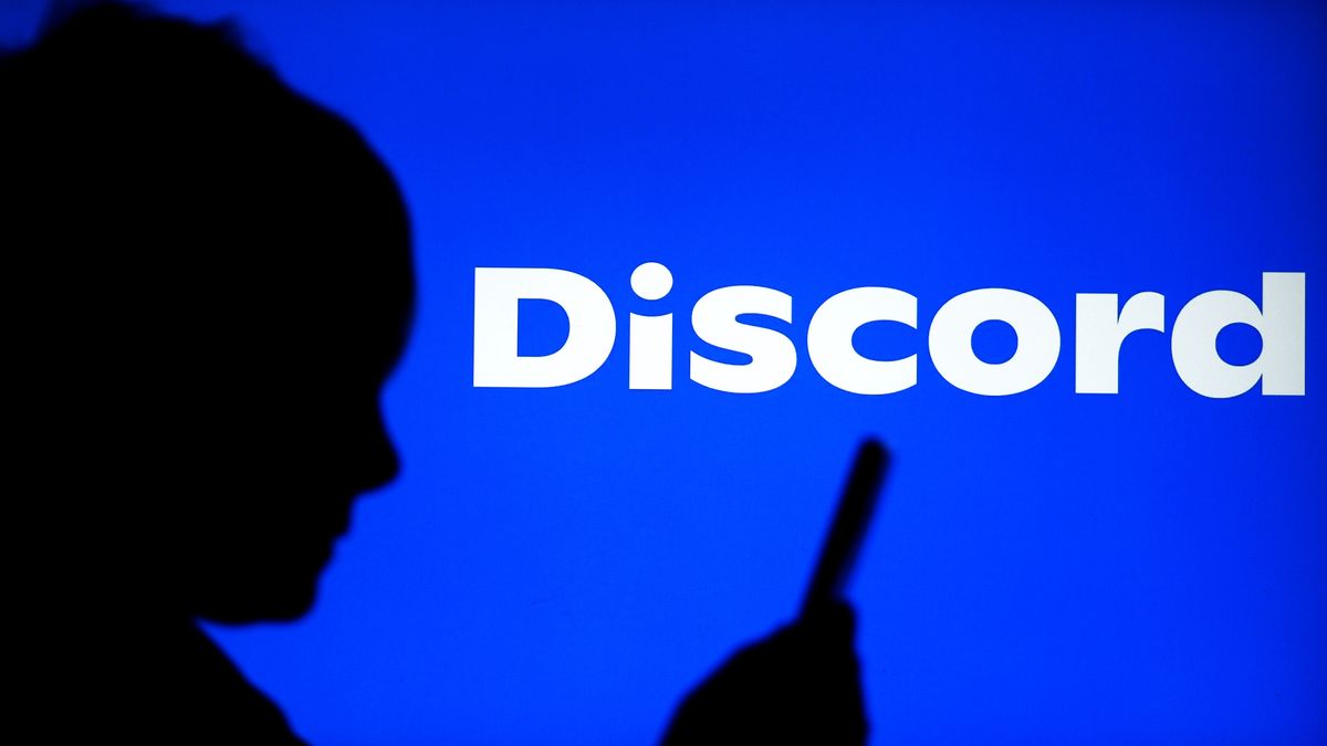 GERMANY - 2025/04/06: In this photo illustration, a Discord logo seen on display with a child watching something on his phone. (Photo Illustration by Valera Golovniov/SOPA Images/LightRocket via Getty Images)