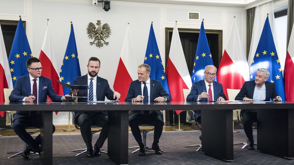 WARSAW, POLAND - 2023/11/10: Szymon Holownia (L), head of the Poland 2050 party, Wladyslaw Kosiniak-Kamysz, head of the Polish People's Party, Donald Tusk (C), head of the Civic Coalition, Wlodzimierz Czarzasty, the co-chairman of the New Left party, and Robert Biedron (R), the other co-chairman of the New Left, sign the coalition agreement in the Parliament. The leaders of Polish opposition parties have signed a coalition agreement that lays out a road map for governing the nation over the next four years. The parties collectively won a majority of votes in last month's parliamentary election. Their candidate to be the next prime minister is Donald Tusk, a former prime minister who leads the largest of the opposition parties, the centrist Civic Platform. Tusk said the parties worked to seal their agreement a day before the Independence Day holiday, adding that, "We wanted to show that we are ready to take responsibility for our homeland." He said the agreement would offer a set of "signposts and recommendations" for the government he plans to lead. (Photo by Attila Husejnow/SOPA Images/LightRocket via Getty Images)