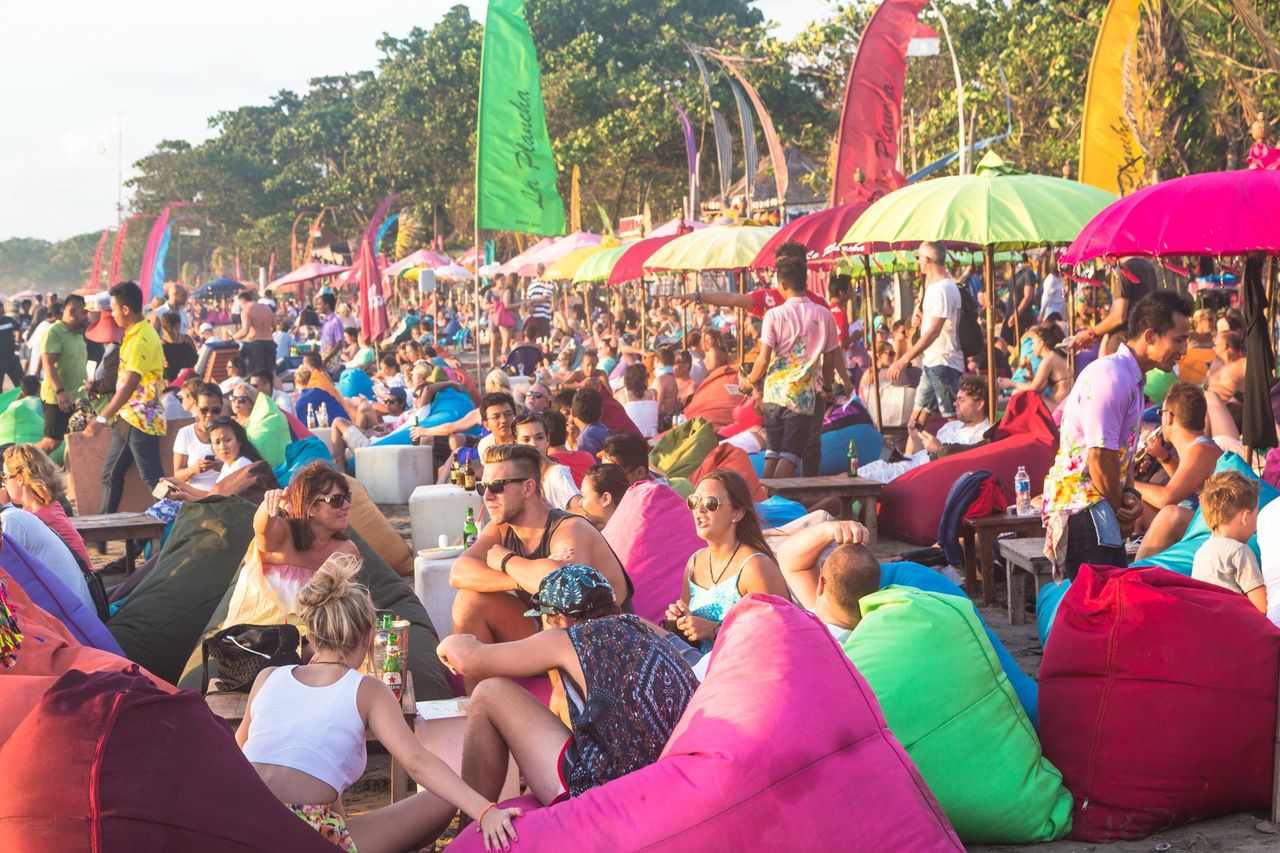 A crowd of partygoers on Bali beach