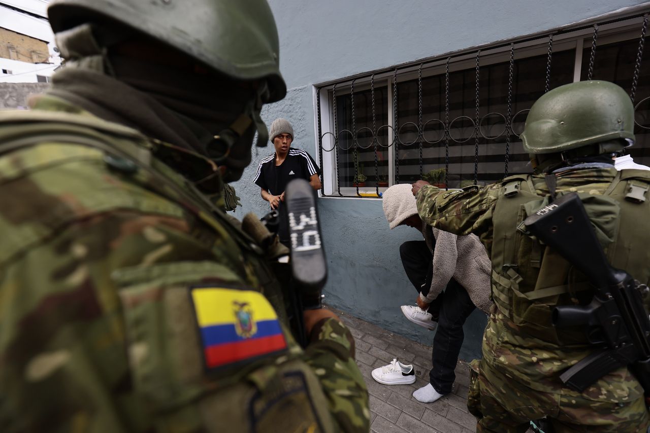 QUITO, ECUADOR - JANUARY 15: Military personnel inspects people for illegal objects during an operation against gangs on January 15, 2024 in Quito, Ecuador. President Daniel Noboa declared "internal armed conflict" after hooded and armed men broke into TC Television's live broadcast. Ecuador is under a state of emergency while Noboa has ordered military operations to neutralize armed gangs. Ecuador has been hit by explosions, police kidnappings, and prison disturbances after gang leader Adolfo "Fito" Macias escaped from a prison in Guayaquil. (Photo by Franklin Jacome/Agencia Press South/Getty Images)