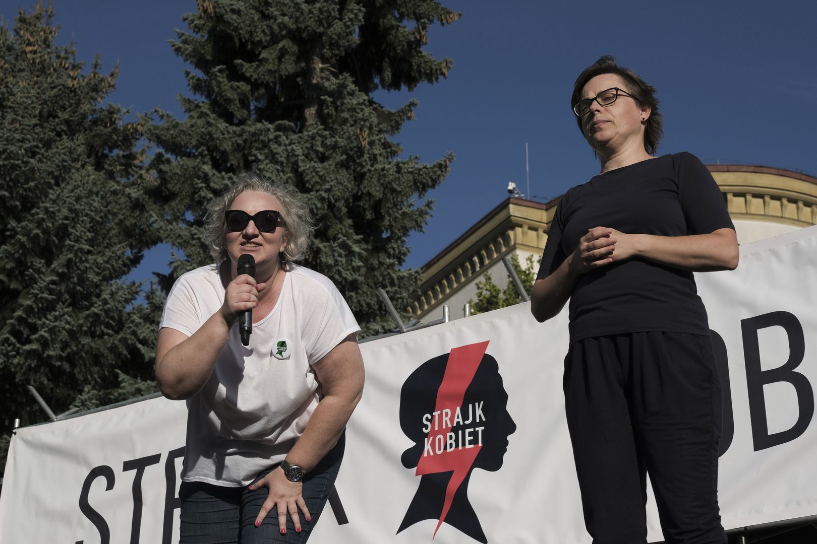 Marta Lempart, leader of All-Poland Women's Strike, left, speaks to protesters during a pro-abortion demonstration, by the All-Poland Women's Strike, outside the Polish parliament in Warsaw, Poland, on Tuesday, July 23, 2024. Polish Prime Minister Donald Tusk's government failed to pass legislation to decriminalize abortion in a tight vote, laying bare divisions within the ruling coalition on an issue that's polarized the nation. Photographer: Damian Lemanski/Bloomberg via Getty Images