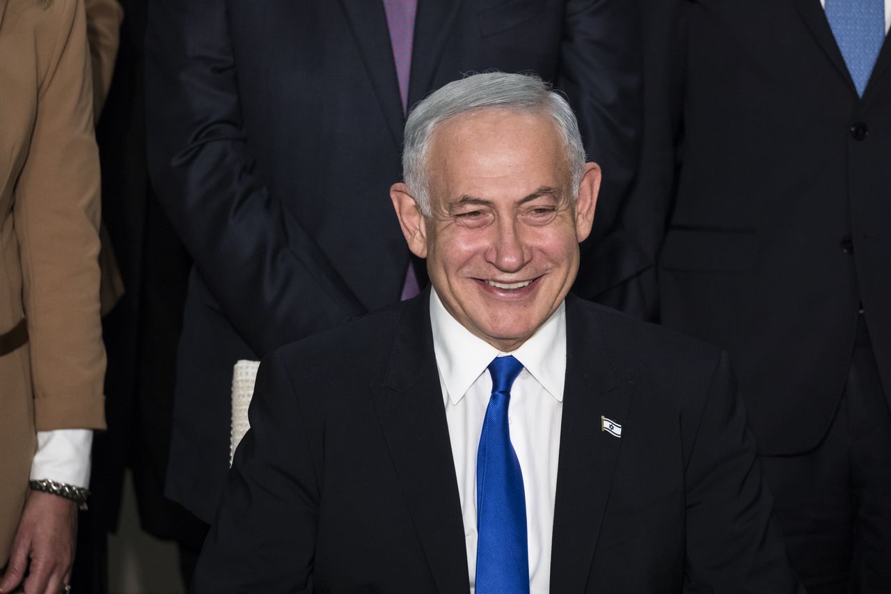 JERUSALEM, ISRAEL - DECEMBER 29:  Israeli Prime Minister Benjamin Netanyahu smiles during a traditional government group photo at the President's house on December 29, 2022 in Jerusalem, Israel. Conservative Benjamin Netanyahu and a bloc of nationalist and religious parties won a clear election victory last month and will be sworn in as government to the Knesset today. This completes Netenyahu's political comeback with a record sixth term in office.  (Photo by Amir Levy/Getty Images)