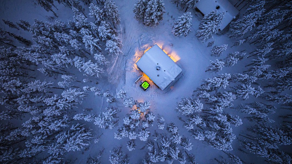 Cottage with hot tub in a snowy forest at dusk, aerial view
Overhead view of a rustic cottage with outdoors hot tub in the middle of a frozen snowy forest at dusk, Lapland, Finland
Roberto Moiola / Sysaworld