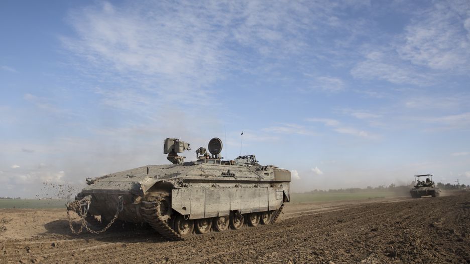 SOUTHERN ISRAEL, ISRAEL - JANUARY 24: Israeli tanks and armored personnel carriers move along the border with the Gaza Strip on January 24, 2024 in Southern Israel. According to Israel, 132 hostages are still held by Hamas in Gaza since the October 7 attack. As the conflict between Israel-Hamas conflict rages on, the IDF focused the military offensive on Khan Younes, now the epicenter of the clashes in southern Gaza. For their part, families of hostages in Israel are urging the Netanyahu government to accept an agreement with Hamas to ensure their release.  (Photo by Amir Levy/Getty Images)