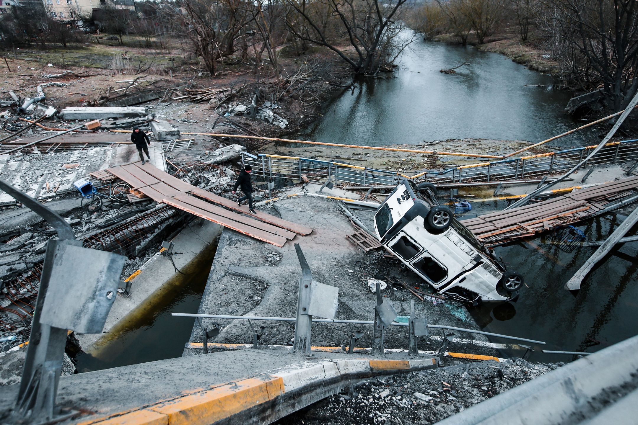 IRPIN, UKRAINE - 2022/04/06: A view of a destroyed van and bridge in Irpin. Irpin is a town located north of Kyiv, heavily attacked and destroyed during the first phase of the war. Russia invaded Ukraine on 24 February 2022, triggering the largest military attack in Europe since World War II. (Photo by Aziz Karimov/SOPA Images/LightRocket via Getty Images)