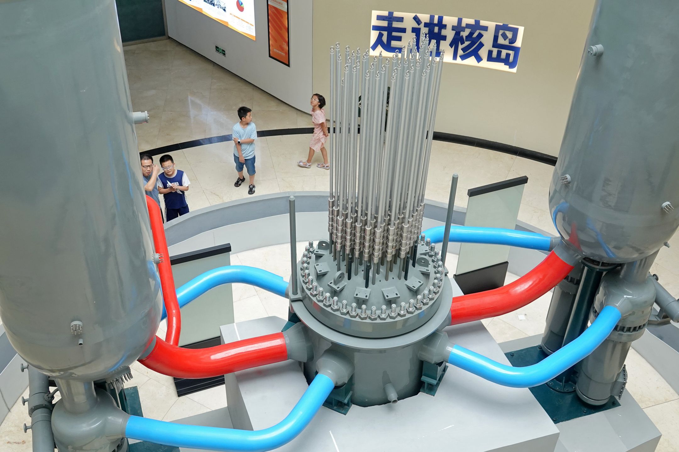 Primary school students are looking at a model of the AP1000 reactor at the Shandong Nuclear Power Science and Technology Museum in Yantai, China, on July 28, 2024. (Photo by Costfoto/NurPhoto via Getty Images)