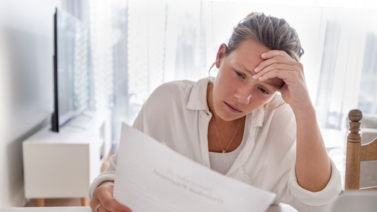 Woman looking worried holding paperwork at home.
Woman looking worried holding paperwork at home. She is reading a financial bill or a letter with bad news. She looks very stressed and upset. There is a laptop computer on the table
courtneyk