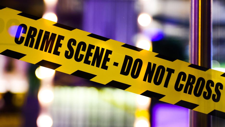 'Crime Scene - Do Not Cross' tape is seen on the entrance door of a restaurant decorated for Halloween in Krakow, Poland on October 31, 2022.  (Photo by Beata Zawrzel/NurPhoto via Getty Images)