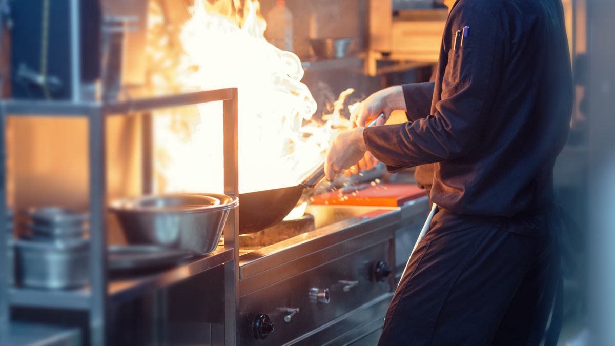 Chefs Preparing Meal In a Wok.Chefs preparing asian food in restaurant kitchen. Preparing Yakiudon. This is real chefs not models.vgajicAsian Cuisine, Cooked, Preparing Food, Photography, Only Men, Men, Males, Two People, Meal, Commercial Kitchen, Stir-Fried, Color Image, Standing, Cooking, Burning, Heat - Temperature, Expertise, Skill, Preparation, Teamwork, Focus - Concept, Motion, Indoors, Waist Up, Horizontal, Side View, Activity, Human Hand, Chef, Professional Occupation, Asia, Spice, Vegetable, Flame, Fire - Natural Phenomenon, Restaurant, Lunch, Dinner, Seafood, Noodles, Food, Uniform, Wok, Frying Pan, Kitchen Utensil, Team, Yaki Udon